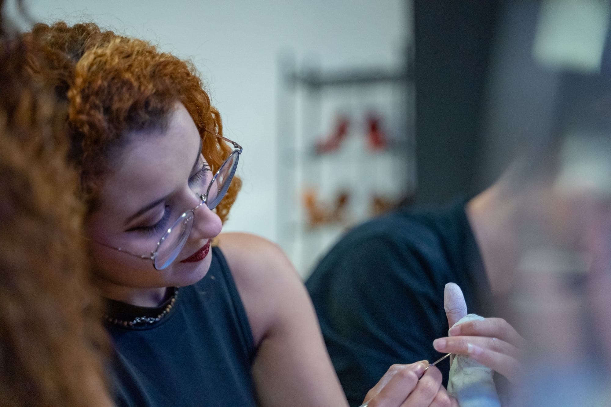 A guest shaping clay during the class.