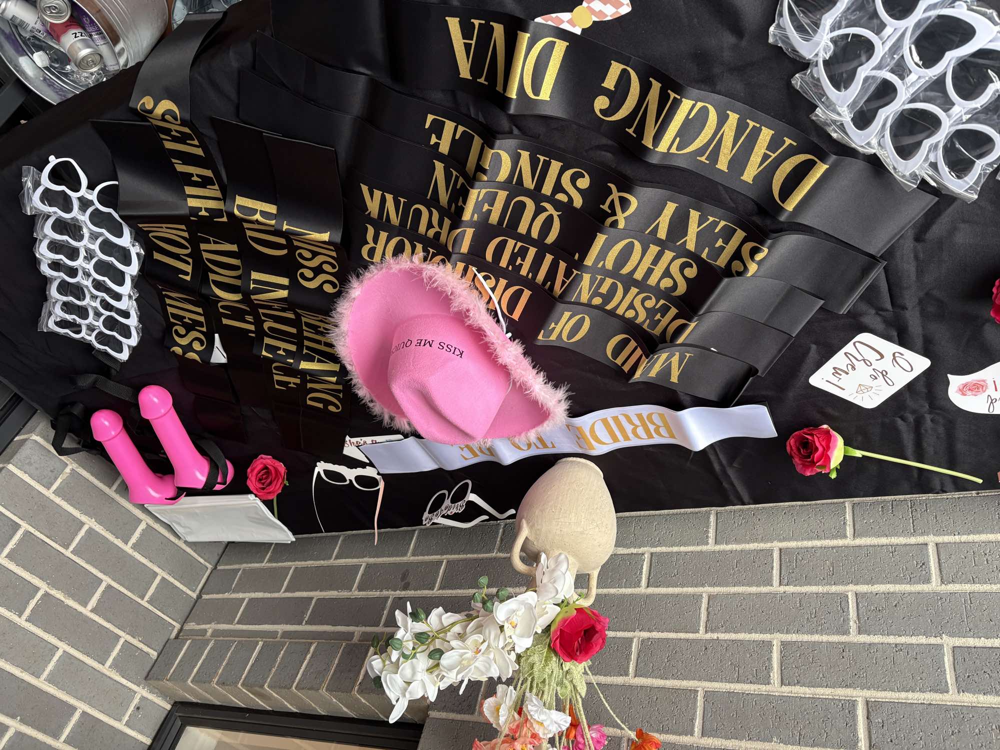 A closer view of hens party sashes, a pink hat and accessories.