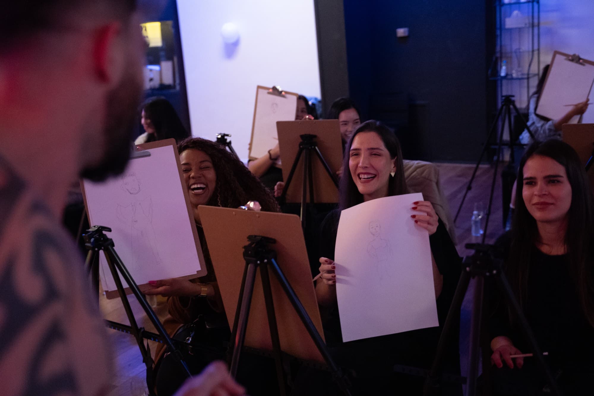 Guests sketching the model at a hens party.